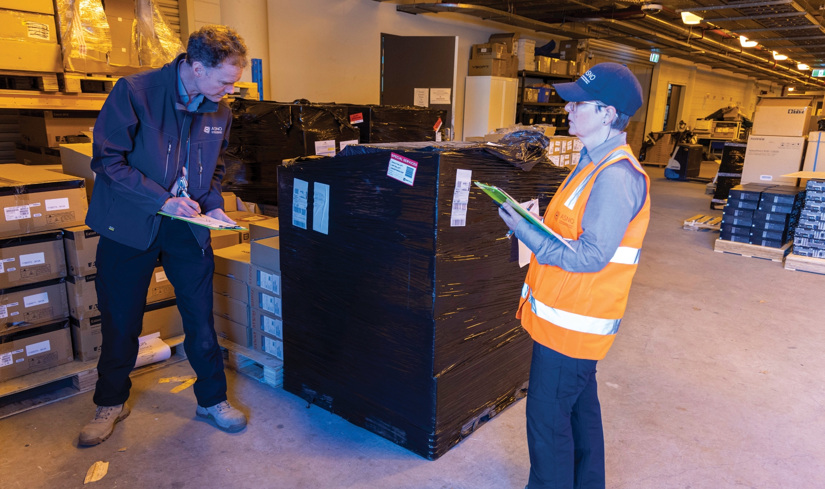 Two ASNO staff conducting an inspection in a wharehouse